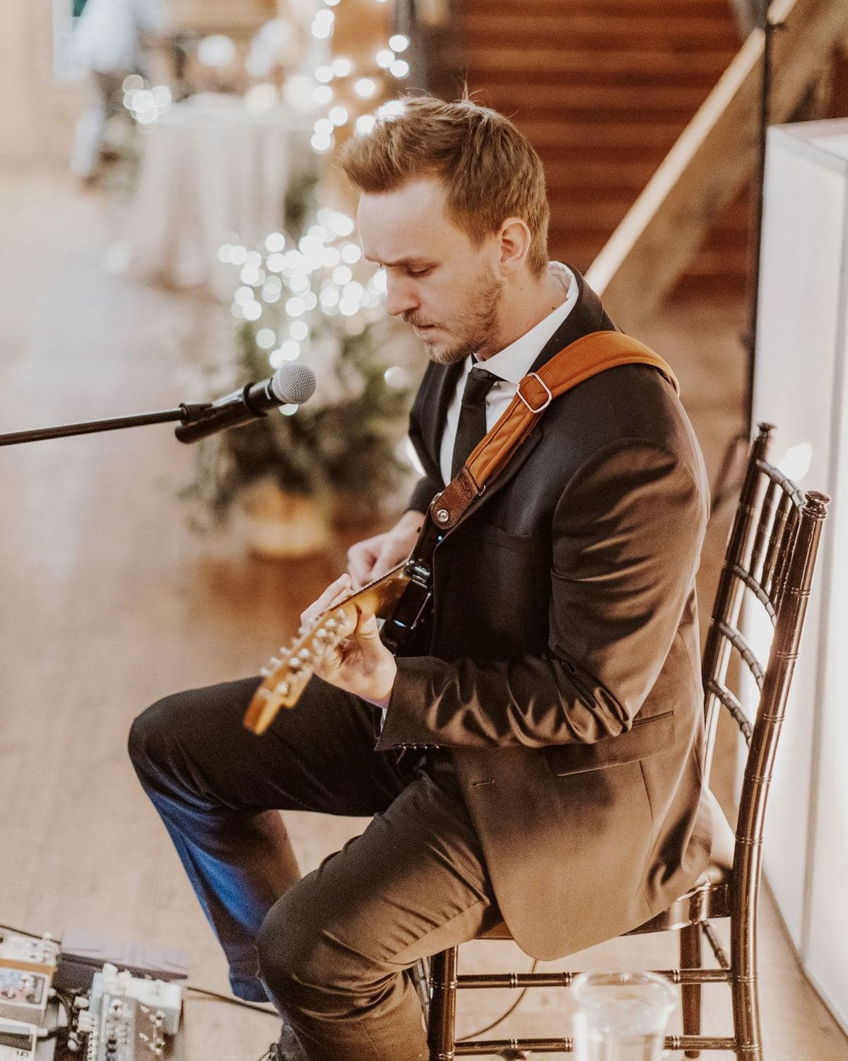 Aaron playing guitar at a wedding